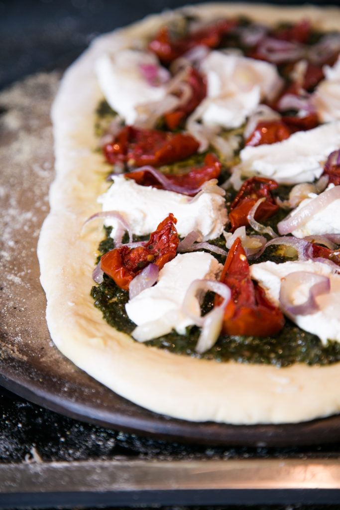 Beet Greens Pesto Pizza with Caramelized Shallots, Goat Cheese and Roasted Tomato