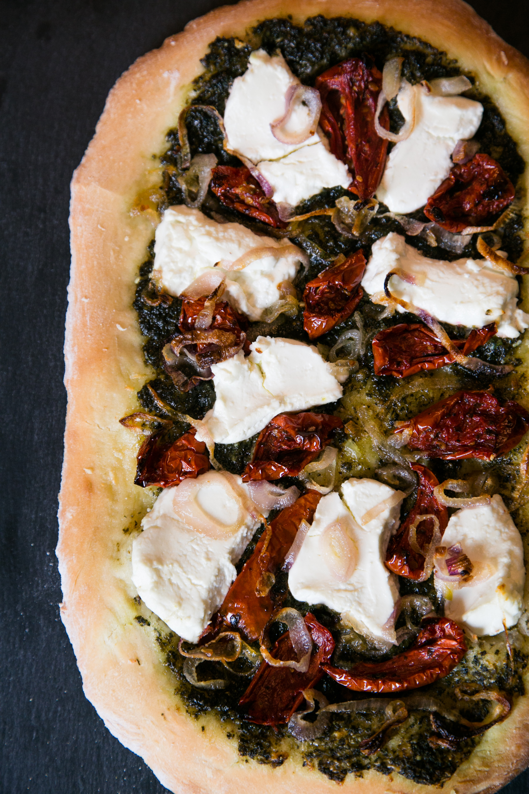 Beet Greens Pesto Pizza with Caramelized Shallots, Goat Cheese and Roasted Tomato